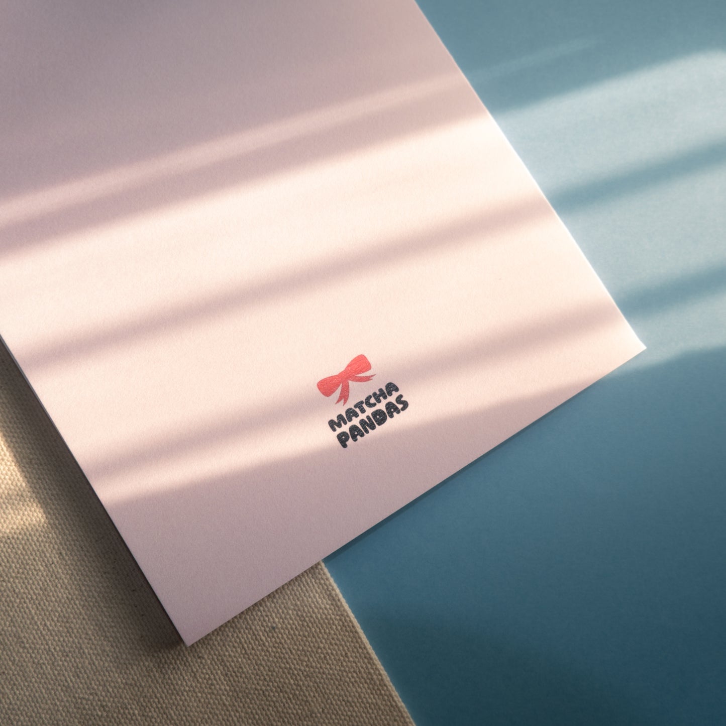 Back of You're Stuck With Me card - Matcha Pandas logo and red bow