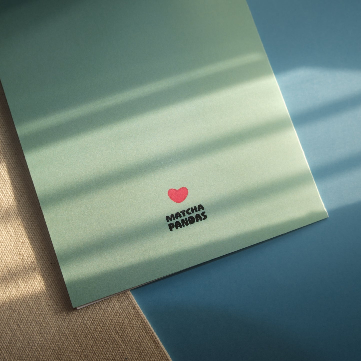 Back of card - Matcha Pandas logo and red heart