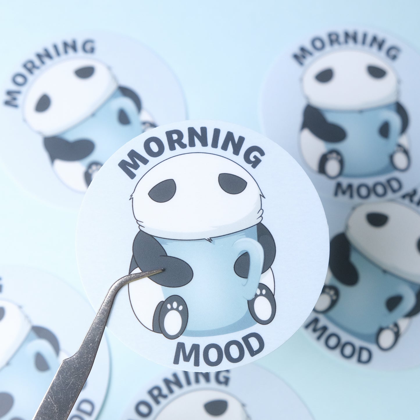 Round sticker of our cute panda with his face in a large mug with the phrase “Morning Mood”