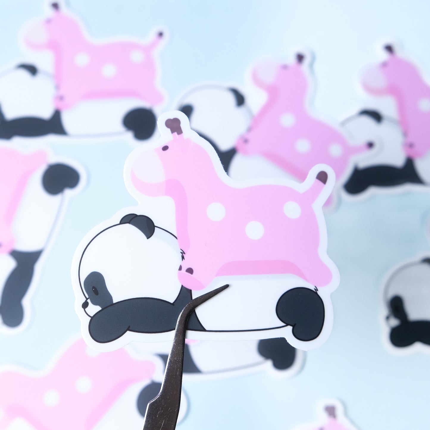 Die-cut sticker of our cute panda lying down with a pink blow up giraffe on his back
