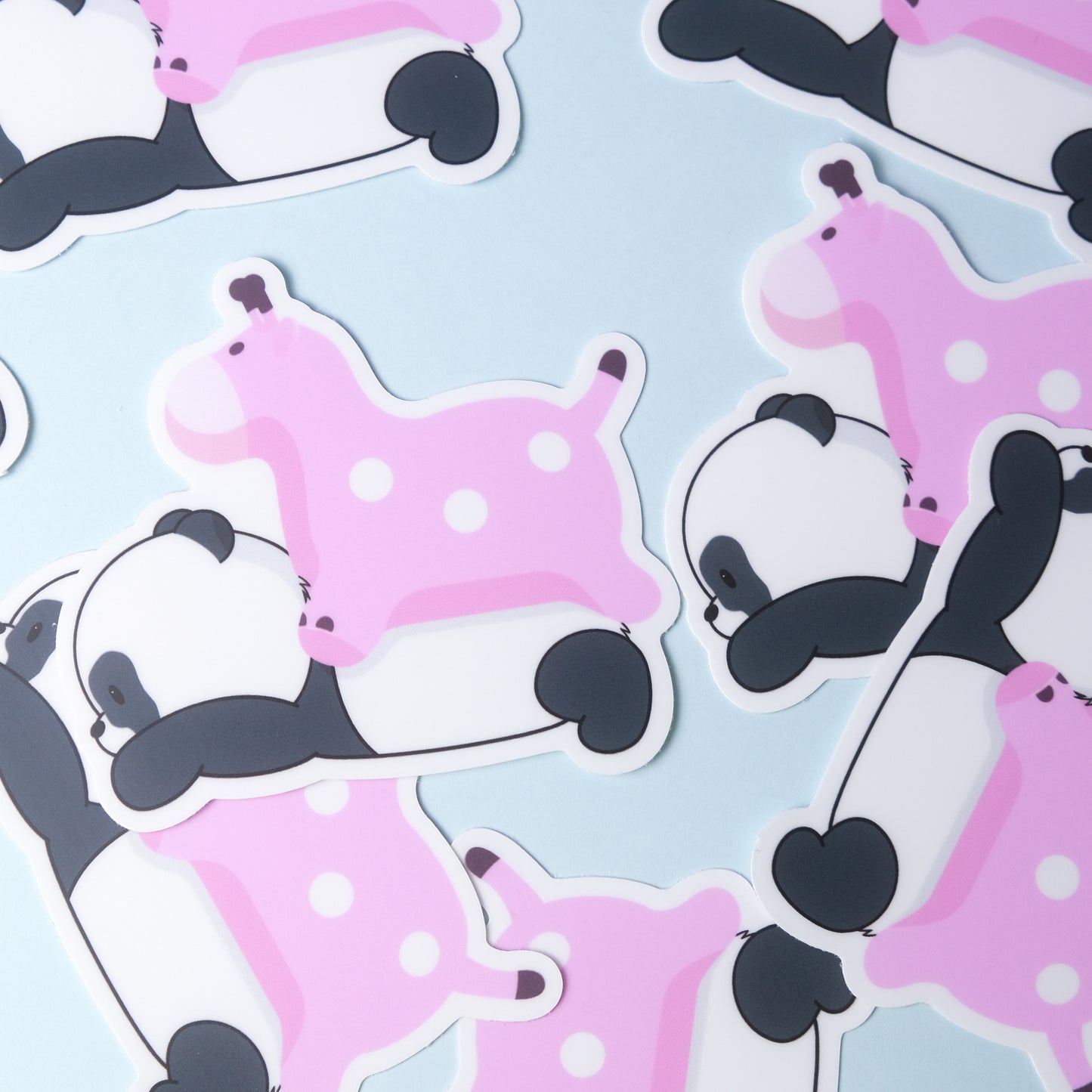 Die-cut sticker of our cute panda lying down with a pink blow up giraffe on his back
