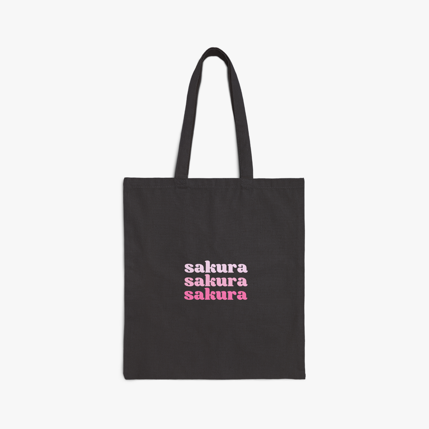 Black tote bag with "sakura" repeated text in pink gradient